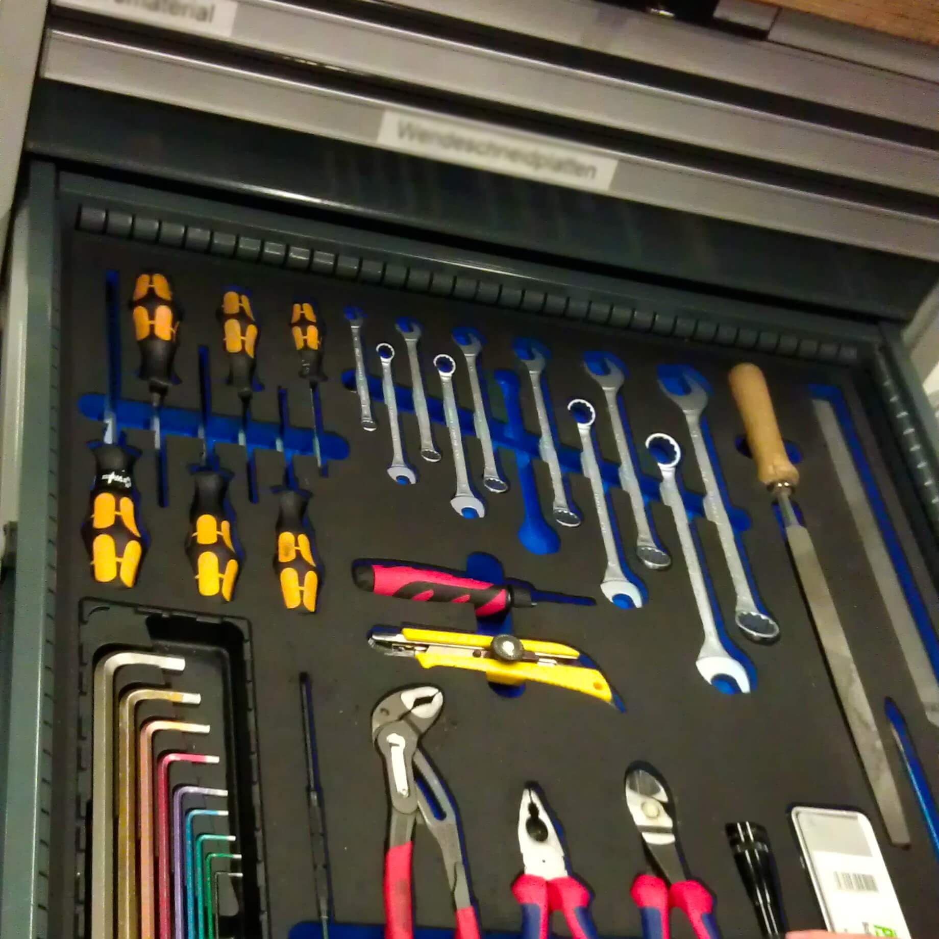 A shadow board in a tool drawer.
